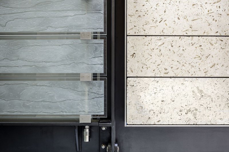 Alignment of kiln-fired glass planks and open-textured Portland-stone glass cladding at WCEC.