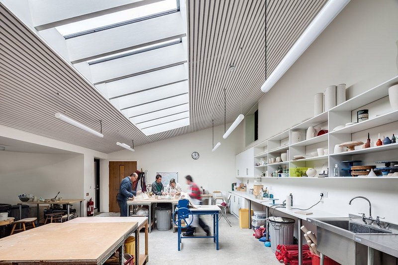 Working together under the bright rooflights in the pottery studio.