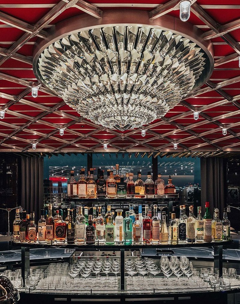 Lasvit created a glass chandelier inspired by the blades of a Concorde Olympus 593 turbine engine above the Brooklands bar at The Peninsula London hotel.