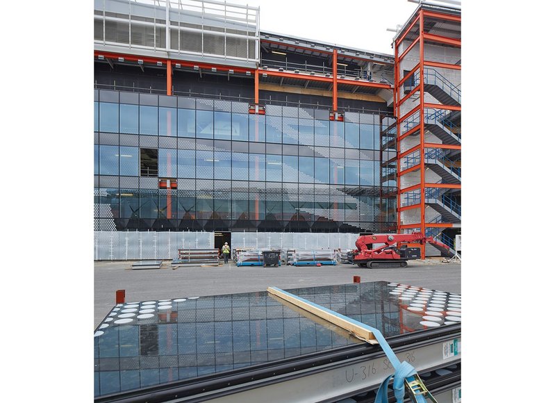 East elevation of Here East during construction, showing the pixellated unitised cladding of the facade. Over time, this will be modified again by the WikiHouse timber system installed in front of it