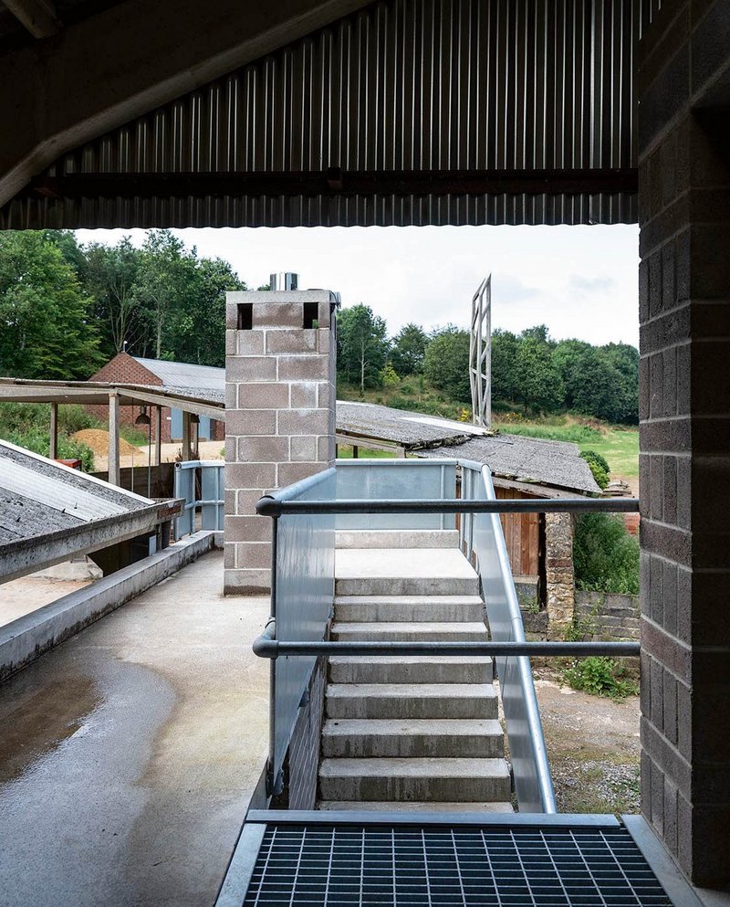 First-floor walkway with view of obelisk by Peter Smithson beyond.