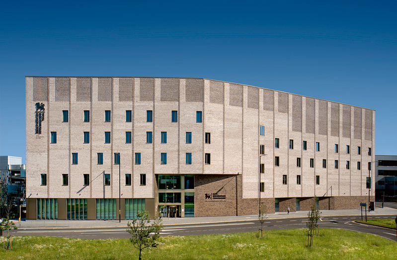 The building’s brick envelope provides a protective castle around the sound- sensitive interior.