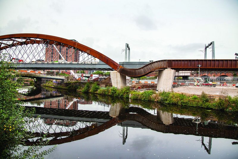 The cascade form enables a seamless transition between the river and the road bridge.