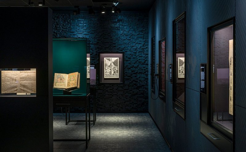 Opplyst, a permanent exhibition at The National Library of Norway, designed by Nissen Richards Studio. The back wall of etched timber blocks was made by contractor Factory Settings.