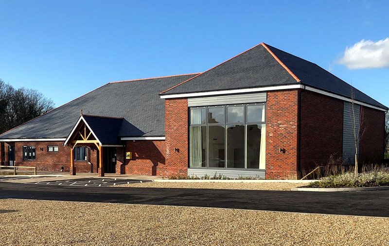 The village hall at Thakeham with Cupa Pizarras Cupa 12 natural slate roofing. The dark grey slate has thin laminations, a smooth surface and can be split to an average thickness of 3.5mm, 5mm and 6mm.