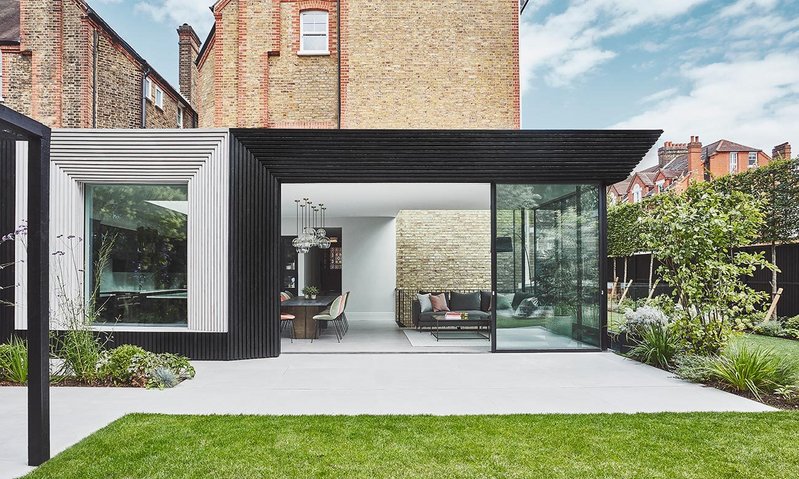 The JAAM-designed burnt-on-blonde Scottish larch clad extension frames a series of Maxlight glazing products. The external brick wall of the main building has been incorporated into the internal living space of the new extension.