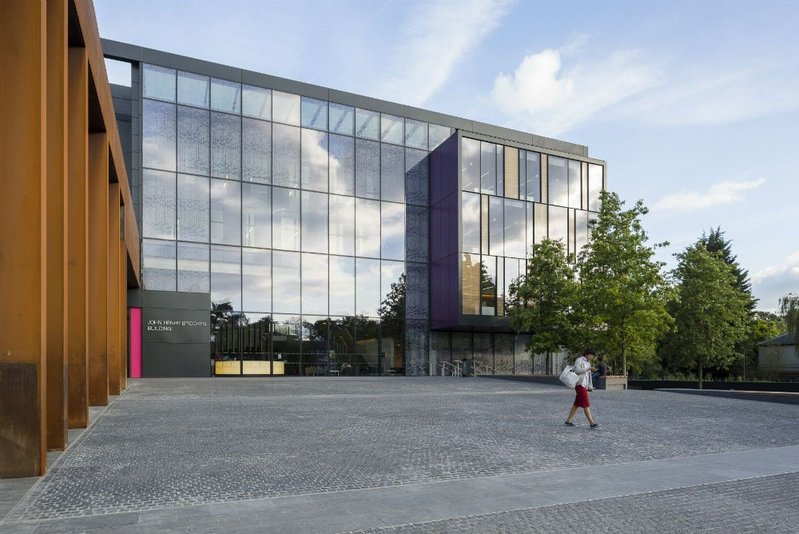 The entrance plaza is a gently sloping ramp flanked by a Cor-Ten colonnade.