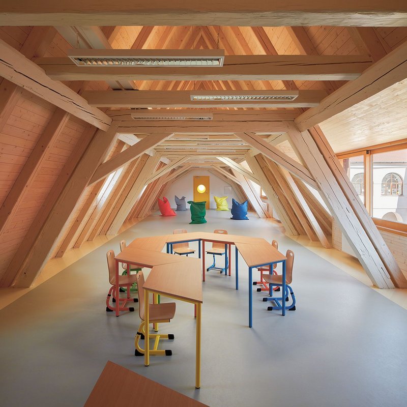 Multi-purpose teaching space with an attic feel and marmoleum floor.