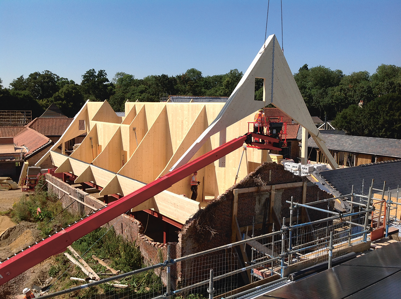 Digitising an existing barn allowed new insertions to be accurately modelled. Here a CNC-cut CLT element fabricated off-site to fine tolerances is lifted into the barn at Anstey Hall, Cambridge, avoiding complex temporary works and breathing new life into the heritage structure.