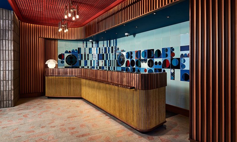 Timber slats and geometric tiles set the scene in the hotel’s reception.