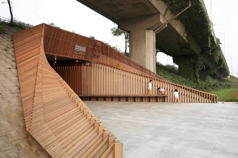 Seongsan Underpass with a reworked entrance in slatted wood hinting at the landscape beyond rather than acting as a reminder of the civil engineering above and below.