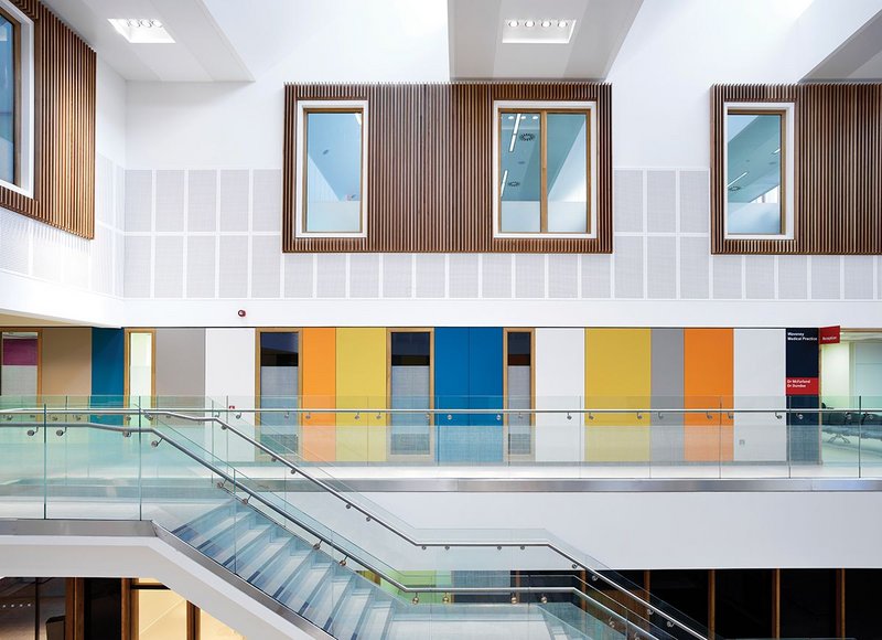 View from GP surgery walkway across the atrium. Light enters the space through glazing in the sawtooth roof.