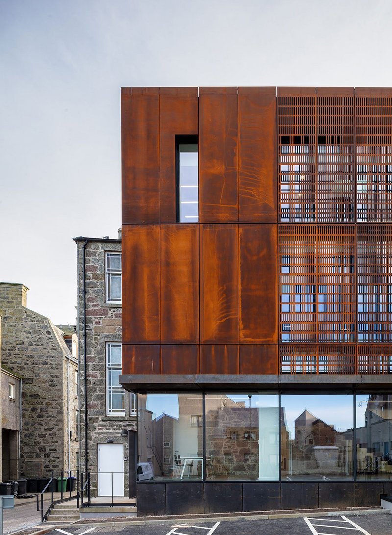 The Corten and glass outer skin is like a carapace over the old; translucent in parts to allow the existing to be read past the new.