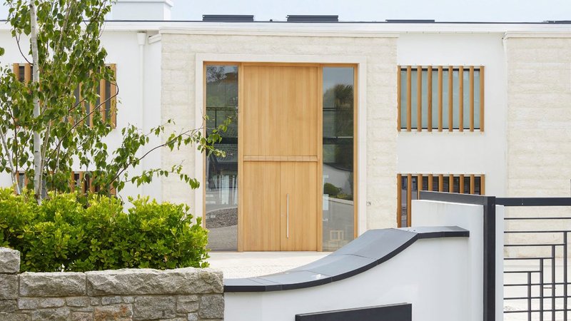 Realise your design vision with a custom door: Urban Front Porto doorset in Oak with matching boarded overhead panels and side lights and Option 11 handle.