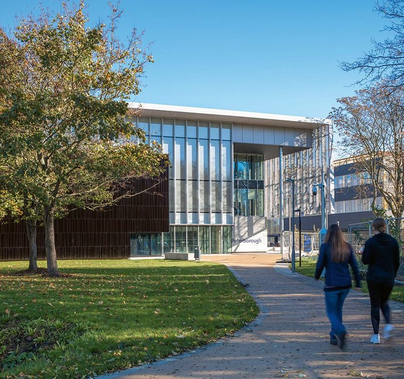 A wide tarmac path draws students from the old centre to Phase I of ARU Peterborough’s new university campus.