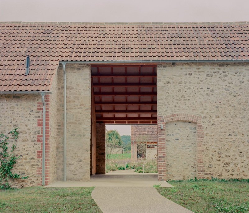 A new 'breezeway' leads from the parking area to the courtyard.