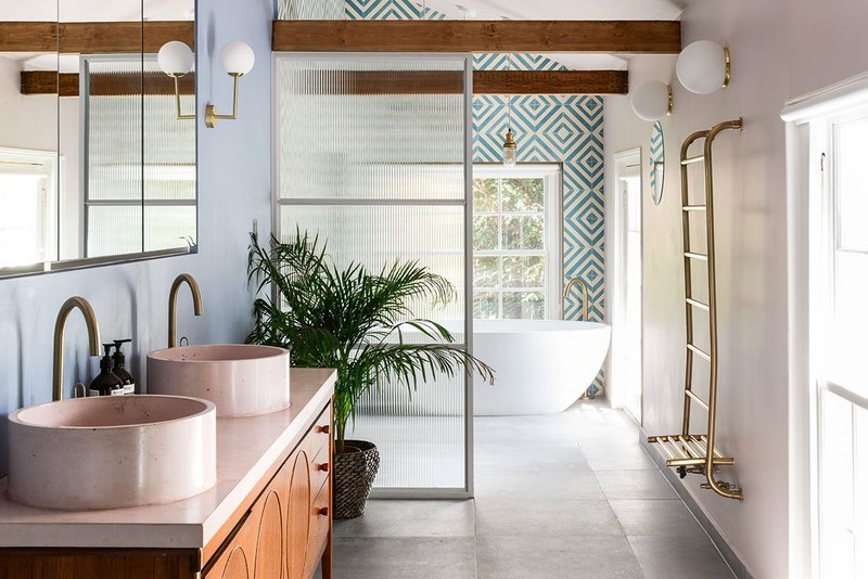 The juxtaposition of cast concrete with mid-century modern creates the showcase vanity unit in this eclectic bathroom.