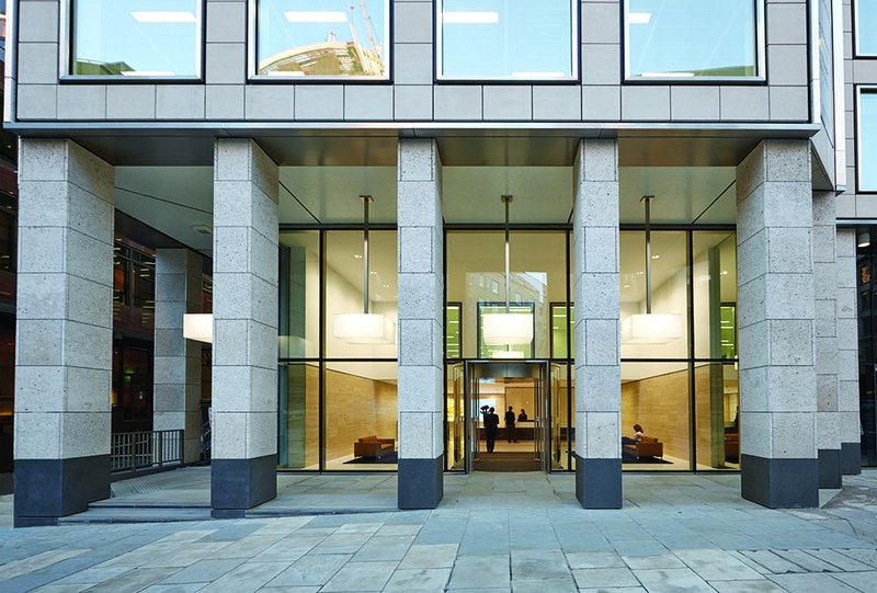 The entrance loggia  is clad in shell-rich Portland stone and incorporates access to the re-routed High Walk.