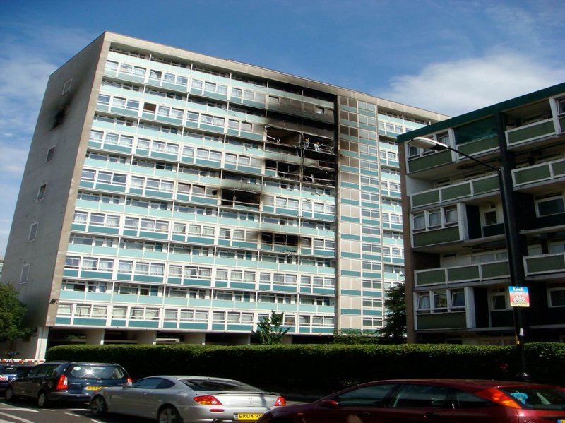 The two men in hard hats on the 11th floor are standing in flat 79 of Lakanal House in Southwark. The fire broke out two floors below. The other two lower fires were caused by burning debris blowing in open windows.