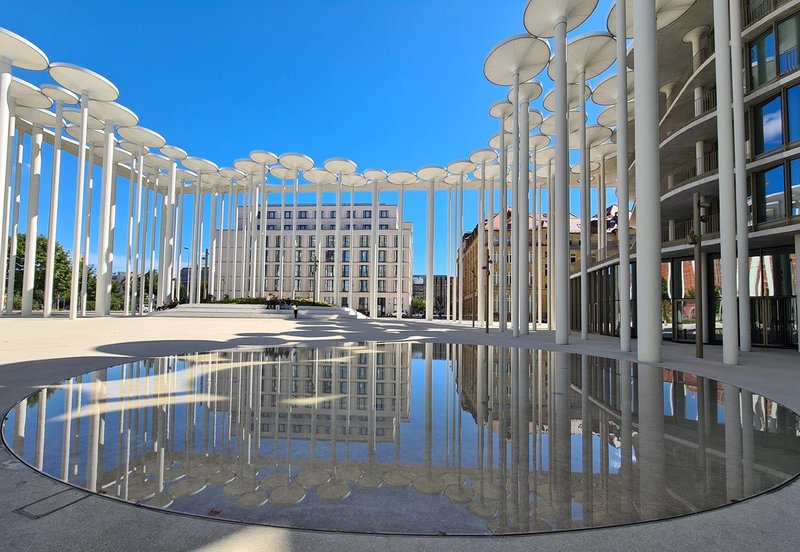 Columns are reflected in the pool at ACME’s completed SAB Forum public space, inspired by an Alice in Wonderland forest.