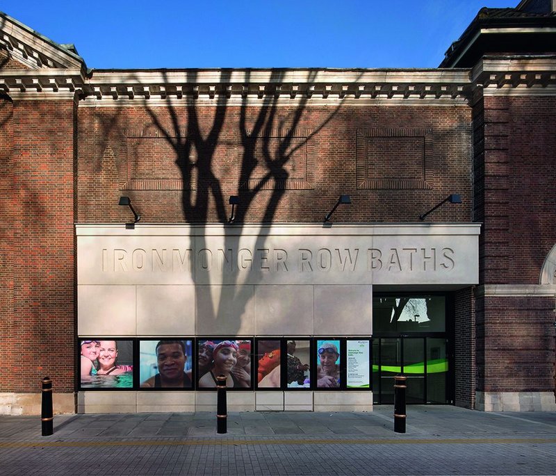 The bold new cast-stone entrance sits at the join between the original building and its late 1930s extension.