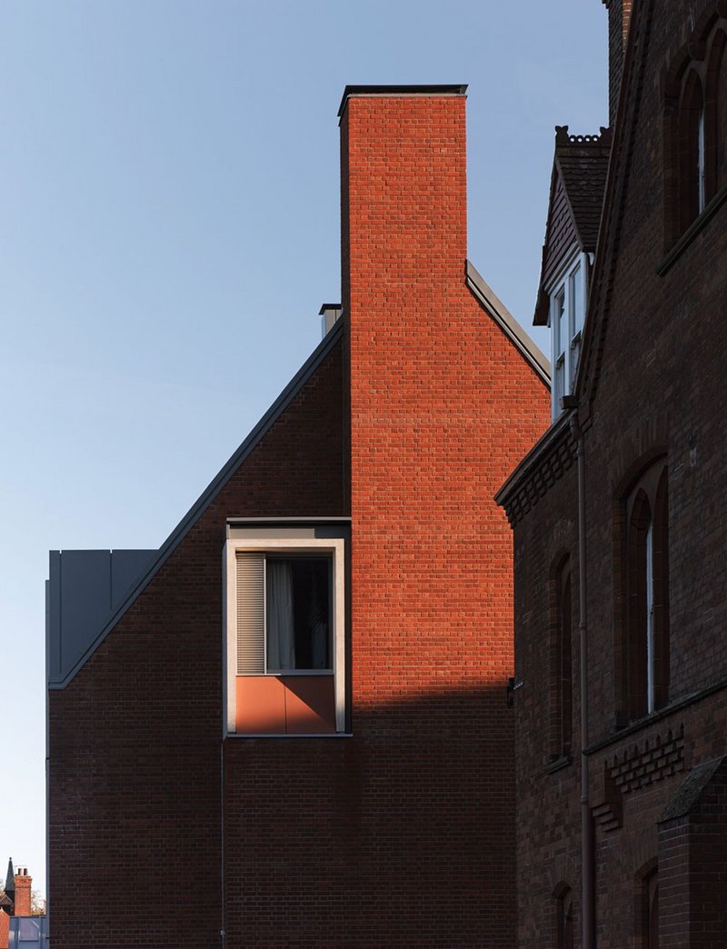 Gable end. Concrete frames the window ensemble and terracotta cladding.