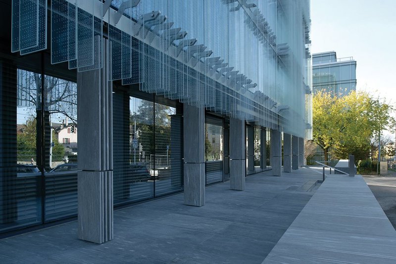Vertical striations in glass are emulated  in the cladding of the steel colonnade at ground level.