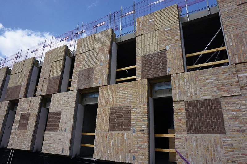 Panels set in steel frames and mounted on the timber/concrete composite structure.