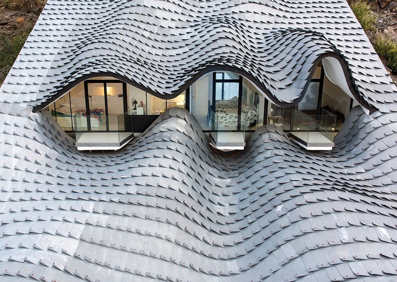 Spain’s Casa del Acantilado’s zinc shingles adapt to every curve of the building’s roof form