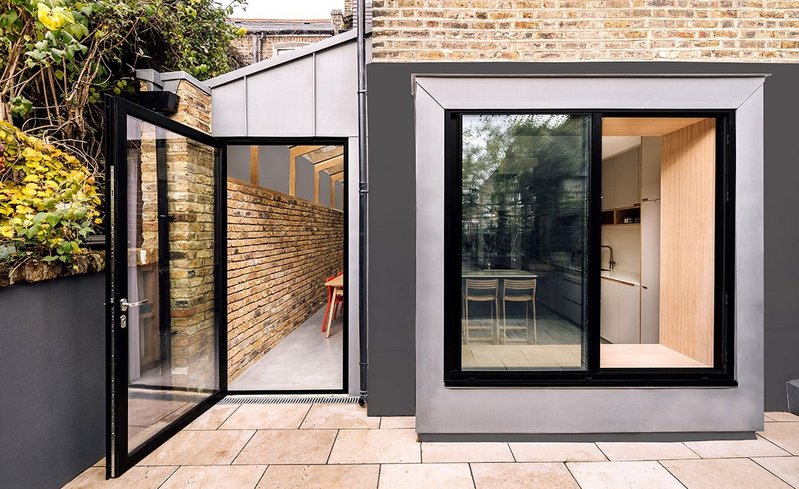 The Stoke Newington kitchen extension: 'We requested something modern and more creative than the standard side returns you see in the area,' say the clients. 'We now have a raised window with seat, oak beams, polished concrete and exposed brick.'