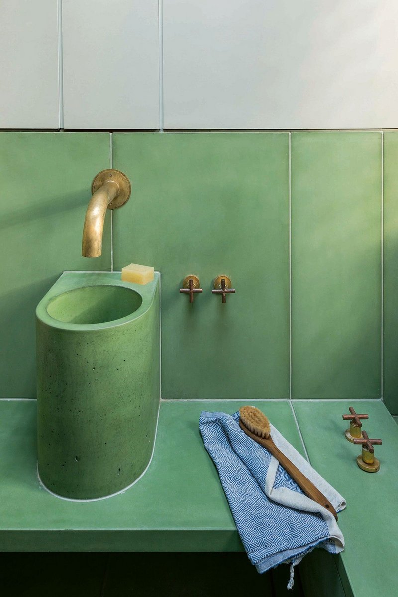 Hand-made water spouts are counterpointed by off-the-shelf taps, stripped of their chrome coatings to reveal the brass below.