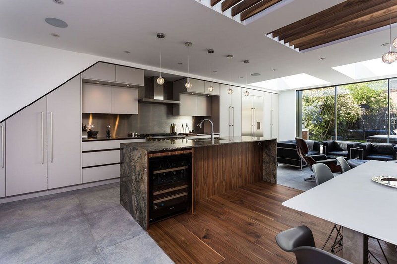 Roundhouse Urbo matt lacquer and bookmatched walnut veneer kitchen and living room furniture with bookmatched black walnut vertical veneer, Tremendal granite and stainless steel.