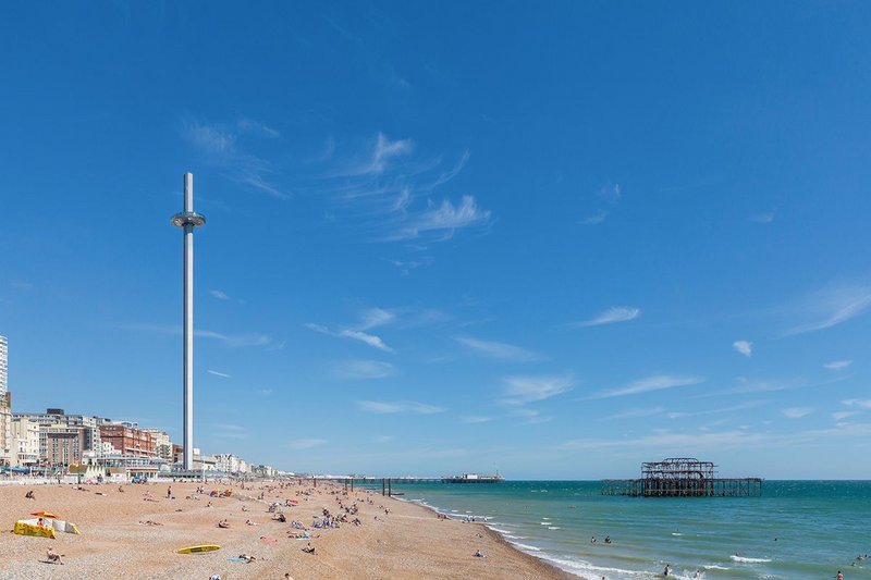 British Airways i360 with the ruins of West Pier to the right and Brighton Palace Pier beyond.