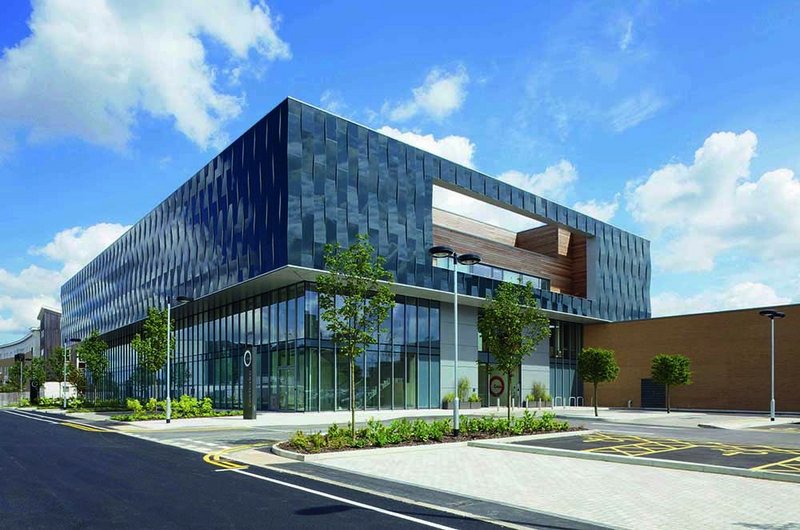 The main face of the building is the raised ‘basket weave’ pierced glass of the in-patient wards.