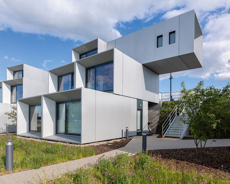 At the Dyson Institute in Wiltshire cantilevers of 3m for each storey give a strong overall shape to the student residences against the green bund.