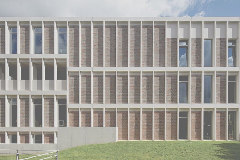 The façade is a simple grid in brick and pre-cast concrete.