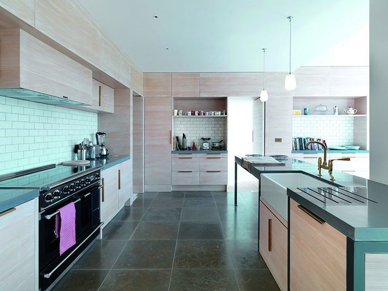 Pale grey tiles and pale Douglas fir  counterpoint the dark blue limestone floor