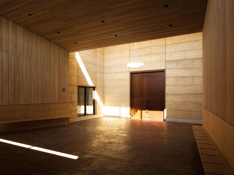 The rammed earth prayer halls lit by clerestory glazing which allows light to flood into the double-height space.