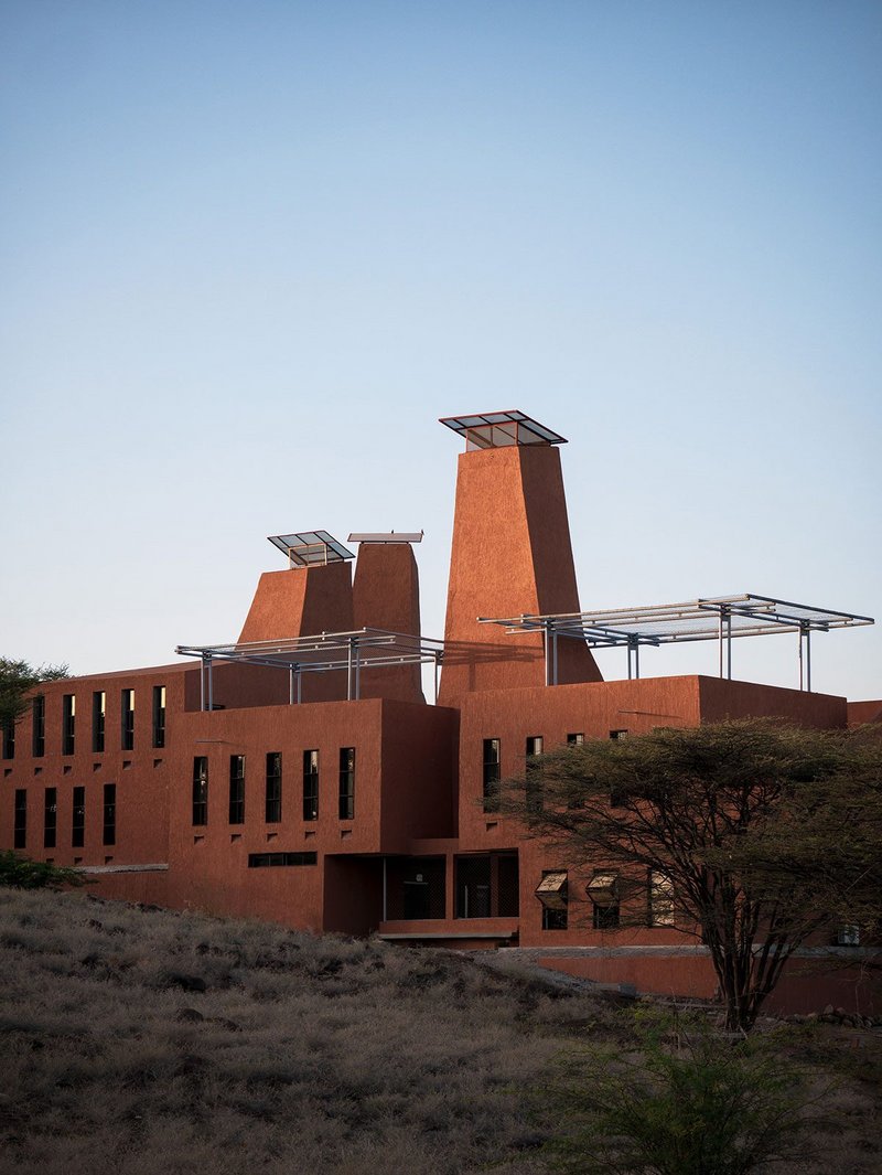 Startup Lions Campus is made of rock from the site it is built on. Creeping vegetation is intended to grow over light steel frames on the roofs.