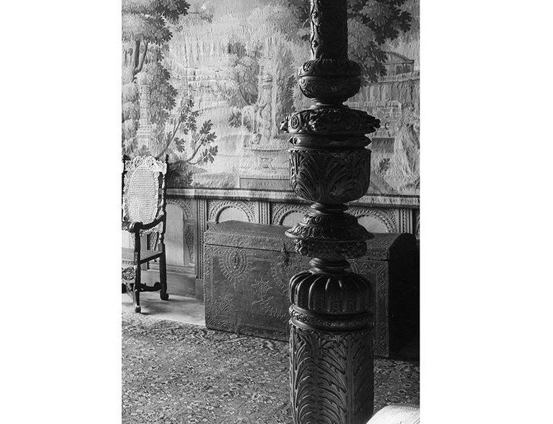 Draping walls with tapestries is a simple way of improving the comfort in old buildings, as here in the Crimson bedroom, Montacute House, Somerset.