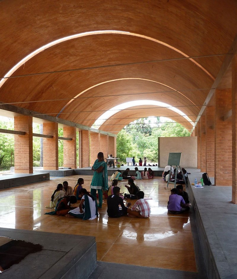 Sharanam Centre for Rural Development  in Pondicherry, India. The low-carbon campus was hand-built from earth in a landscape that has been ravaged by illegal quarrying. Nothing was wasted: sieved pebbles from the earth formed flooring finishes and excavation pits were used to harvest rainwater. A local drip system was revived, reducing irrigation water requirements by 75 per cent