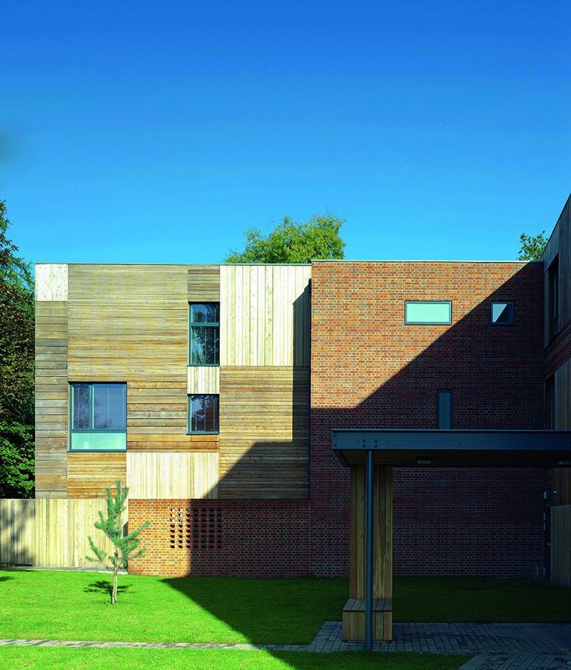 The housemistress’ home is timber clad, its front door given a modicum of privacy by a partially perforated brick wall.