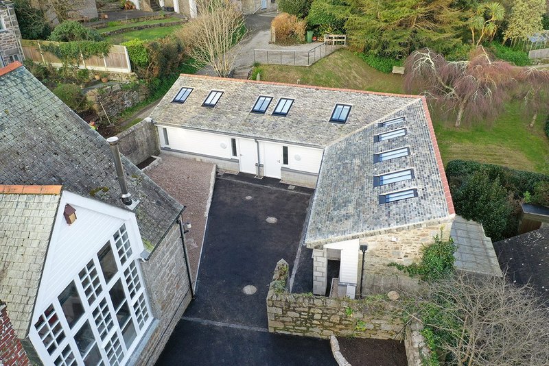 Ten new rooflights sit flush with Cornish slate, which sits on battens and counterbattens in a warm roof build-up.