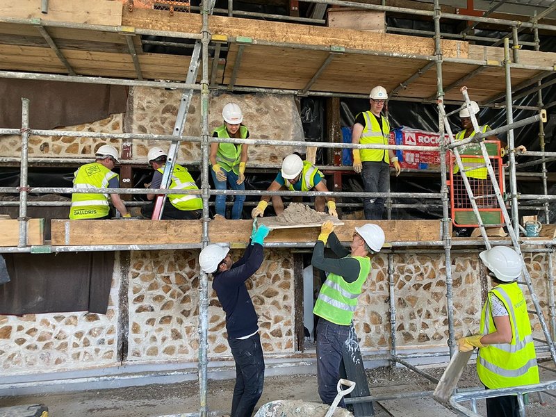 Members of the DSDHA team volunteering with Yes Make on the construction of a community building at the Paper Garden meanwhile space at Canada Water.