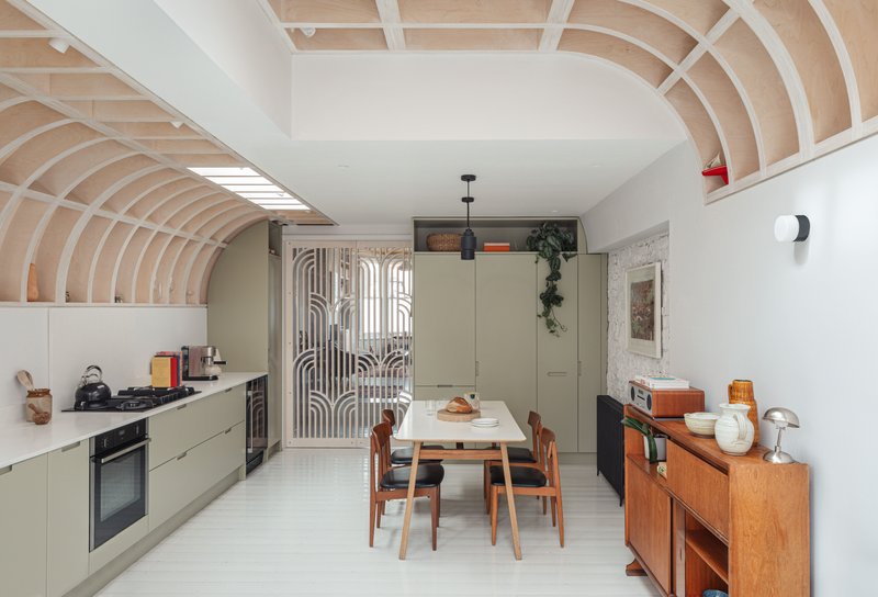 A bespoke sliding door screens off the newly extended kitchen.