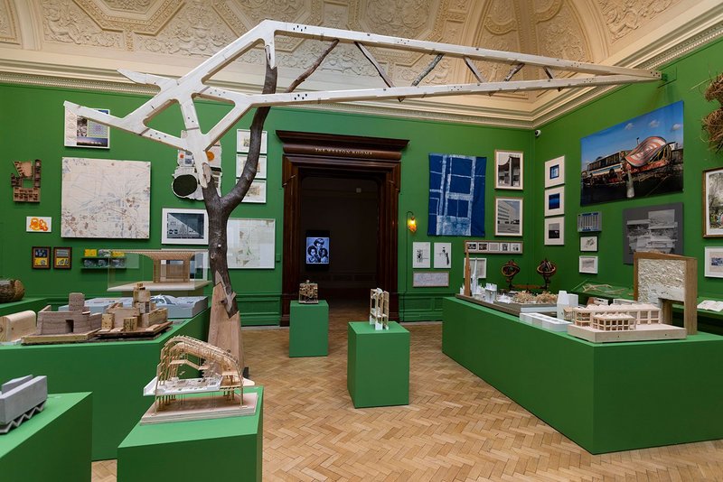 Installation view of the architecture room at the Summer Exhibition 2023 at the Royal Academy of Arts in London. The Tree and the Truss, made by students of the Architectural Association, stretches across the gallery.