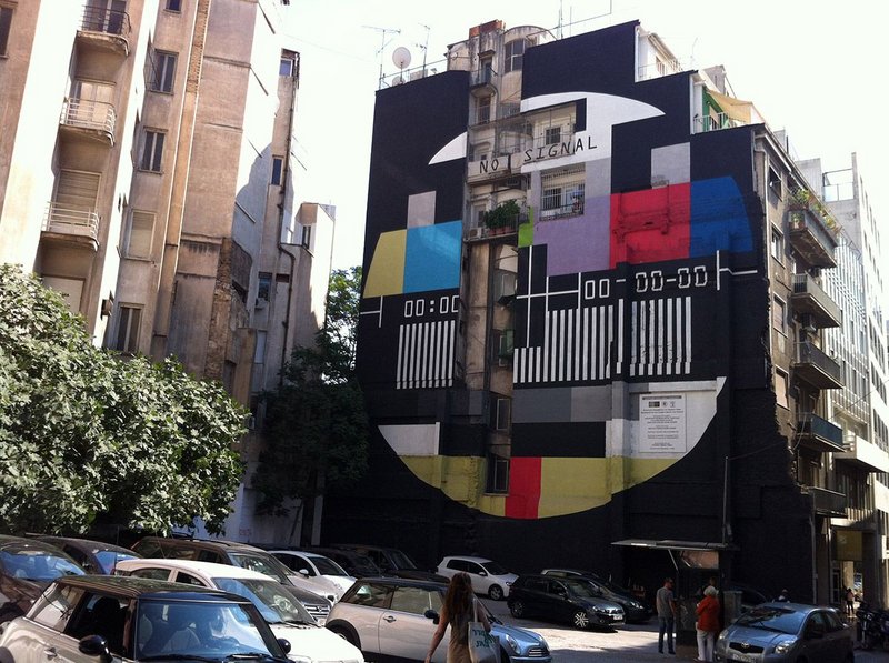 Polykatoikía registering protest.  The side wall of a polykatoikia in Athens, near Syntagma Square, painted with the old 'no signal' image from the national channel ERT, after it was forced to close, 2013.