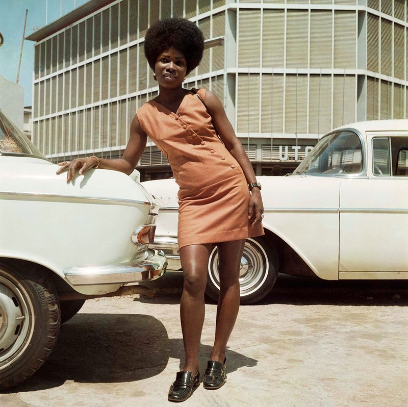 Shop assistant from Sick-Hagemeyer store posing in front of the United Trading Company headquarters, Accra 1971.