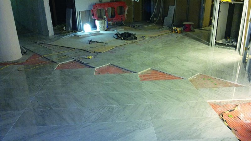 Laying out the floors in lobby areas. Setting out lines are drawn from the tip of the atrium triangle through the centre of the vestibule ellipse