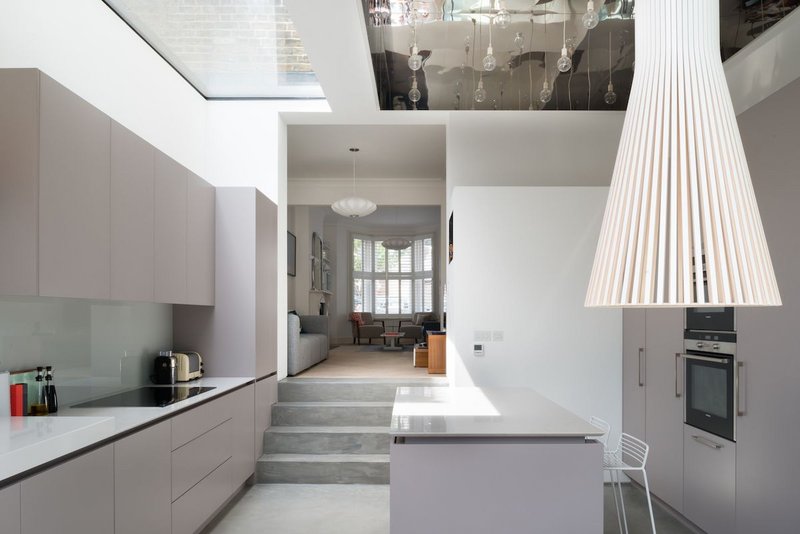 Flushglaze rooflights combine with large light fixtures to make the kitchen of this refurbished Victorian terrace an impressive space.